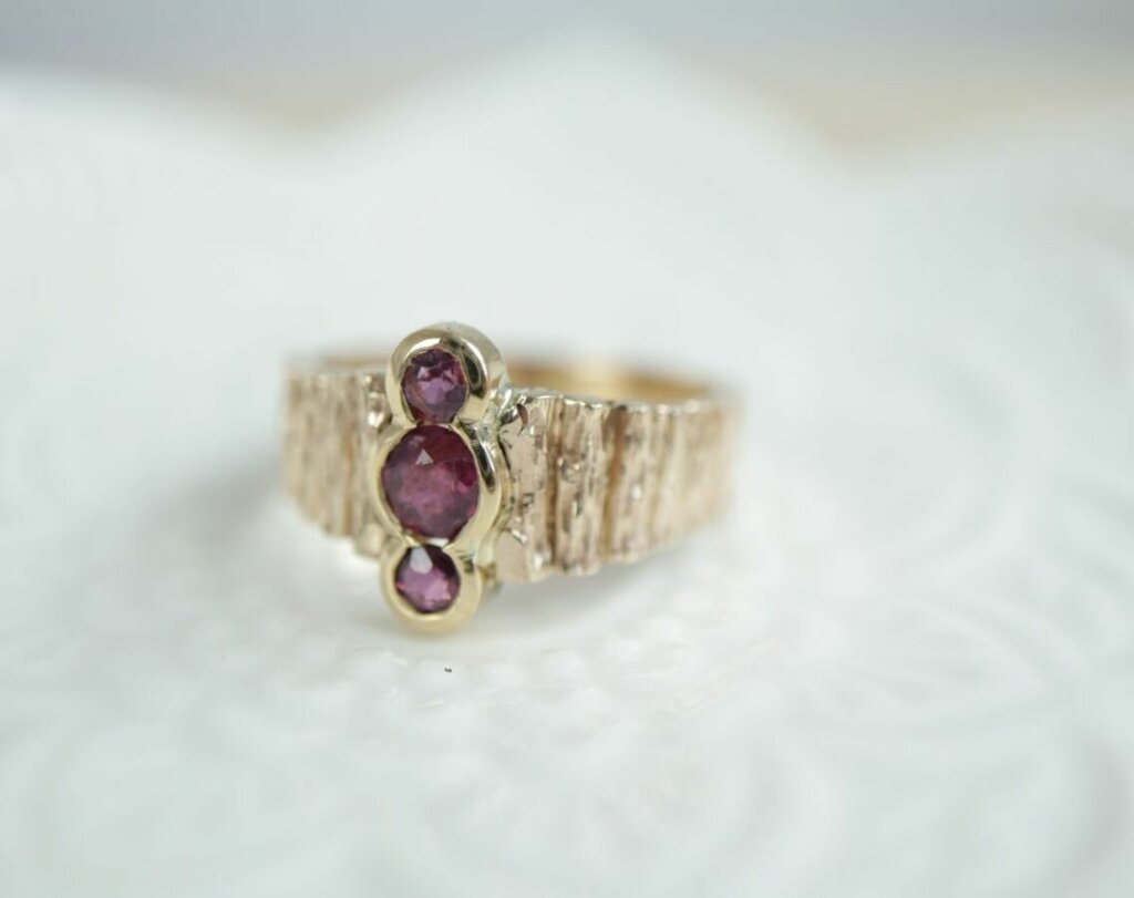 Shared Bezel Set Ruby Ring with Wood Texture Band