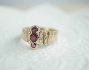 Shared Bezel Set Ruby Ring with Wood Texture Band