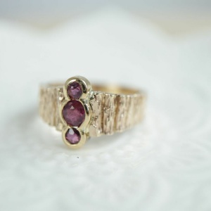 Shared Bezel Set Ruby Ring with Wood Texture Band